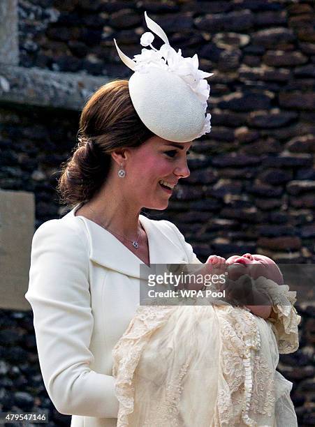 Catherine, Duchess of Cambridge, carries Princess Charlotte of Cambridge as they arrive at the Church of St Mary Magdalene on the Sandringham Estate...