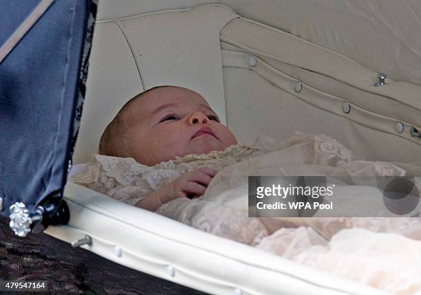 Princess Charlotte of Cambridge is pushed in a pram by her mother Catherine, Duchess of Cambridge as they arrive at the Church of St Mary Magdalene...