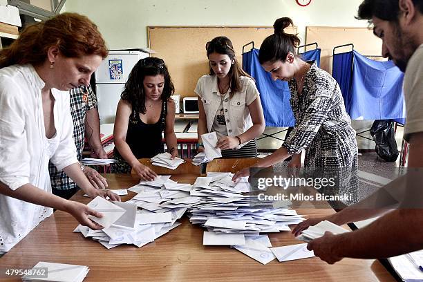 Voting officials count votes after polls are closed in Athens on July 5, 2015 in Athens, Greece. The people of Greece are going to the polls to...