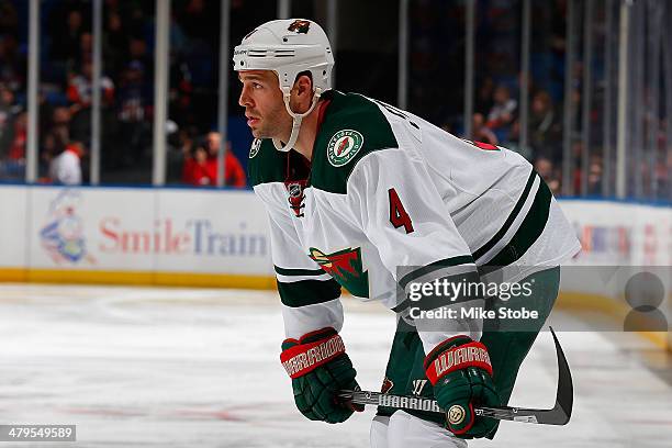 Clayton Stoner of the Minnesota Wild skates against the New York Islanders at Nassau Veterans Memorial Coliseum on March 18, 2014 in Uniondale, New...