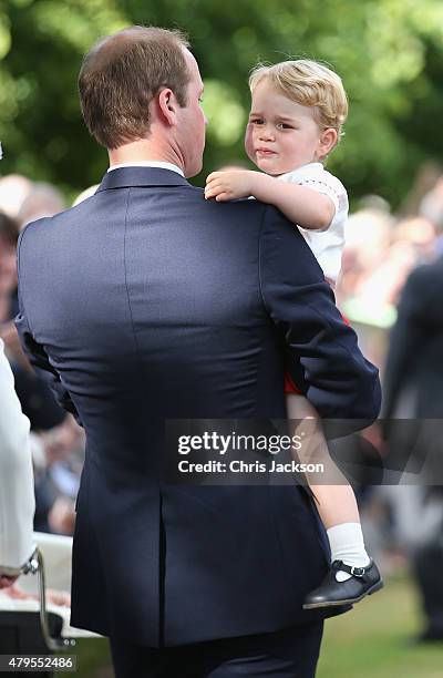 Prince William, Duke of Cambridge and Prince George of Cambridge leave the Church of St Mary Magdalene on the Sandringham Estate for the Christening...