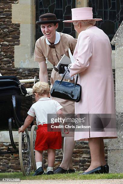 Prince George of Cambridge plays with the wheels of Princess Charlotte's pram as Queen Elizabeth II and Prince George's nanny, Maria Teresa Turrion...