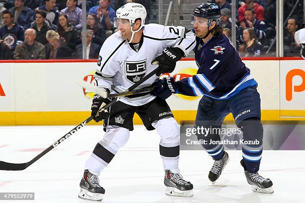 Jarret Stoll of the Los Angeles Kings and Keaton Ellerby of the Winnipeg Jets battle for position as they keep an eye on the play during first period...