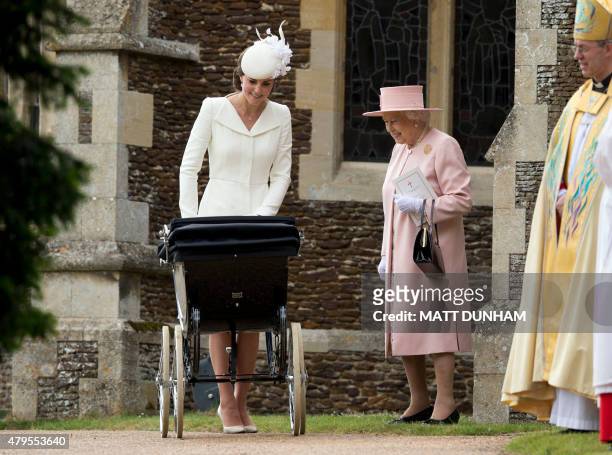 Britain's Catherine, Duchess of Cambridge, pushes her daughter, Princess Charlotte of Cambridge in a pram as Britain's Queen Elizabeth II and...