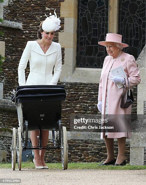Catherine, Duchess of Cambridge pushes Princess Charlotte of Cambridge in her pram as Queen Elizabeth II looks on as they leave the Church of St Mary...