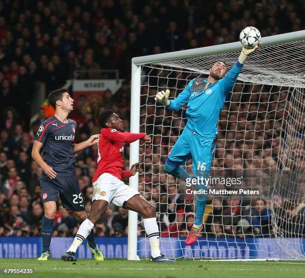 Danny Welbeck of Manchester United in action with Roberto of Olympiacos FC during the UEFA Champions League Round of 16 second leg match between...