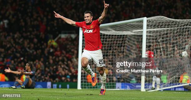 Robin van Persie of Manchester United celebrates scoring their second goal during the UEFA Champions League Round of 16 second leg match between...