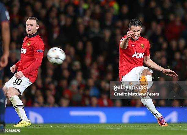 Robin van Persie of Manchester United scores their third goal during the UEFA Champions League Round of 16 second leg match between Manchester United...