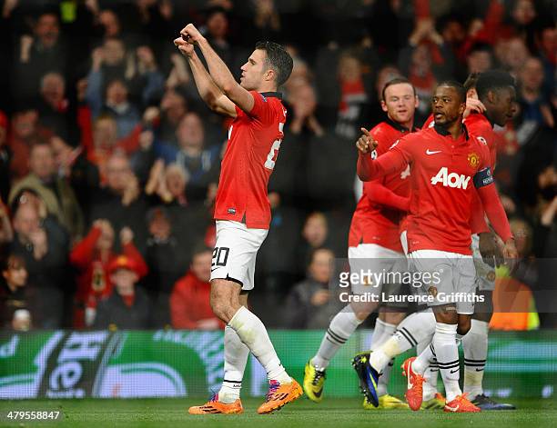 Robin van Persie of Manchester United celebrates scoring the third goal from a free-kick to complete his hat-trick during the UEFA Champions League...