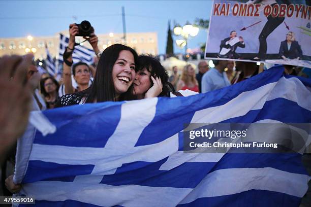 People celebrate in front of the Greek parliament as early opinion polls predict a win for the Oxi, or No, campaign in the Greek austerity...