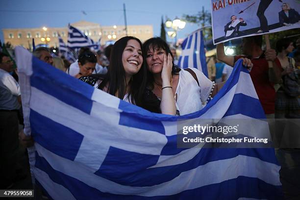 People celebrate in front of the Greek parliament as early opinion polls predict a win for the Oxi, or No, campaign in the Greek austerity...