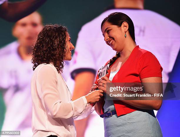 Competition winner Iglika Ivanova recieves her prize from former Spainish international player Veronica Boquete )left) during the third day of the...