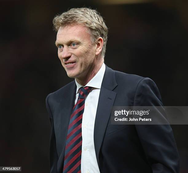 Manager David Moyes of Manchester United celebrates at the final whistle during the UEFA Champions League Round of 16 second leg match between...