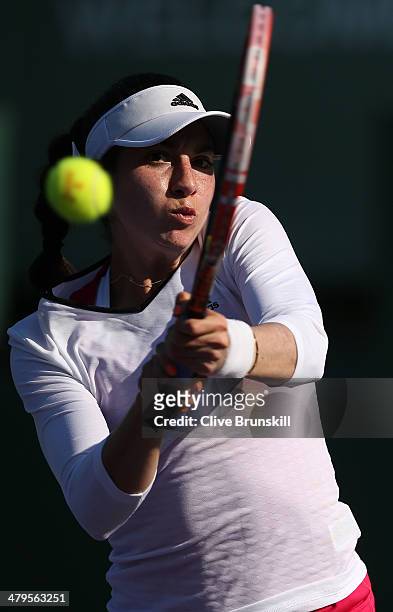 Christina McHale of the United States plays a backhand against Jie Zheng of China during their first round match during day 3 at the Sony Open at...