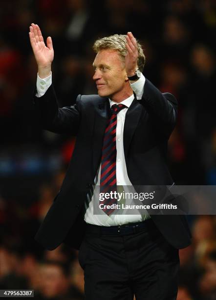 Manchester United Manager David Moyes celebrates at the end of the UEFA Champions League Round of 16 second round match between Manchester United and...