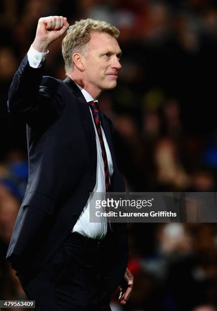 Manchester United Manager David Moyes celebrates at the end of the UEFA Champions League Round of 16 second round match between Manchester United and...