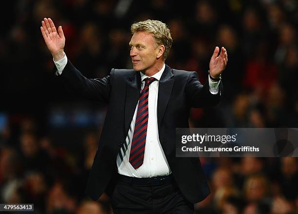 Manchester United Manager David Moyes celebrates at the end of the UEFA Champions League Round of 16 second round match between Manchester United and...