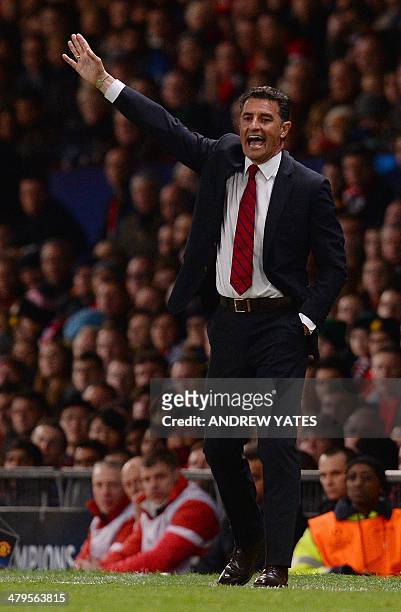 Olympiakos' Spanish manager Michel reacts during the UEFA Champions League round of 16 second leg football match between Manchester United and...