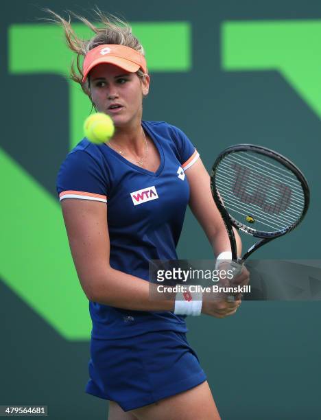 Maria-Teresa Torro-Flor of Spain plays a backhand against Andrea Petkovic of Germany during their first round match during day 3 at the Sony Open at...