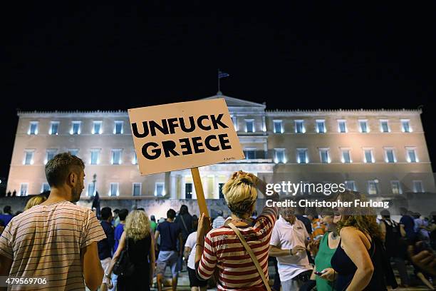 Woman holds a sign in front of the Greek parliament as early opinion polls predict a win for the Oxi, or No, campaign in the Greek austerity...