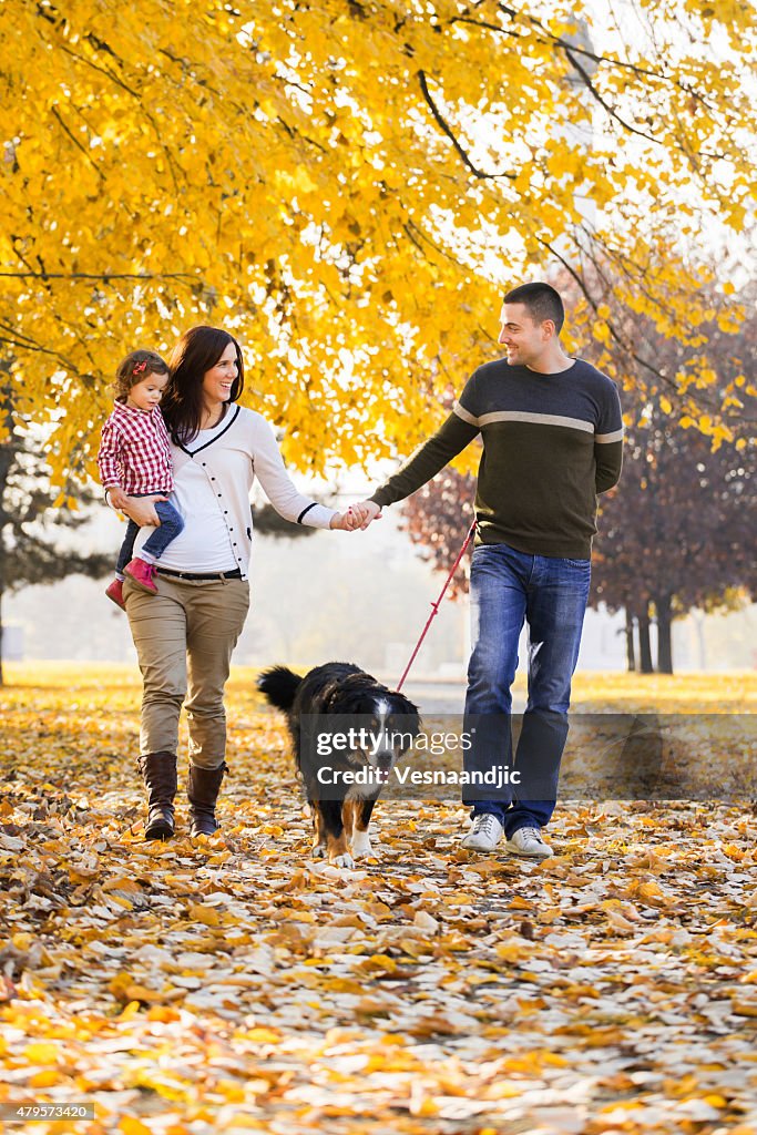 Cheerful family with dog outdoor