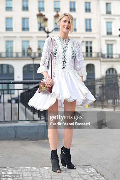 Sofie Valkiers poses wearing Louis Vuitton dress and bag before the Atelier Versace show at the Palais Brogniart on July 5, 2015 in Paris, France.