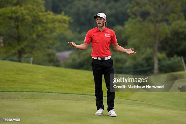 Footballer Gareth Bale gestures to the crowd during the annual Celebrity Cup golf tournament at Celtic Manor Resort on July 4, 2015 in Newport,...