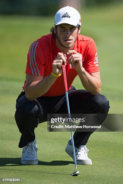 Footballer Gareth Bale lines up a putt during the annual Celebrity Cup golf tournament at Celtic Manor Resort on July 4, 2015 in Newport, Wales. The...