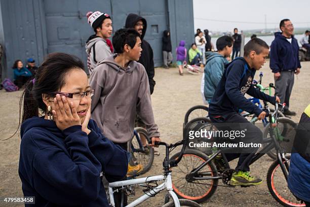 Villagers watch children compete in foot races as a part of Fourth of July celebrations on July 4, 2015 in Newtok, Alaska. Newtok is one of several...