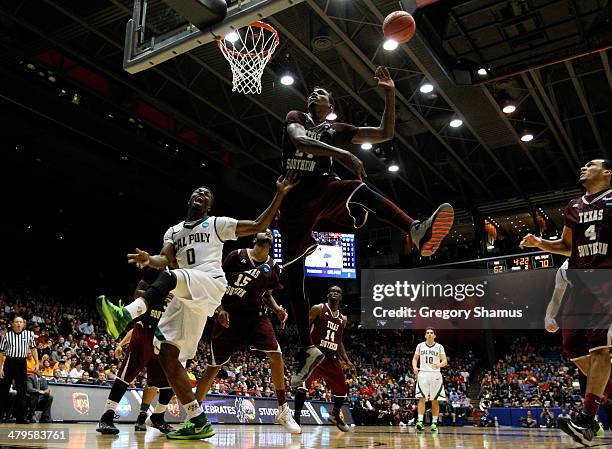 Dave Nwaba of the Cal Poly Mustangs loses the ball as Aaric Murray of the Texas Southern Tigers defends during the first round of the 2014 NCAA Men's...