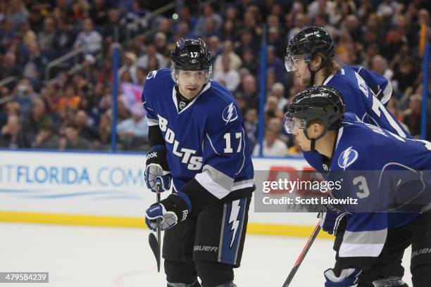 Alex Killorn of the Tampa Bay Lightning talks with teammates Victor Hedman and Keith Aulie during an NHL game at Tampa Bay Times Forum on March 8,...