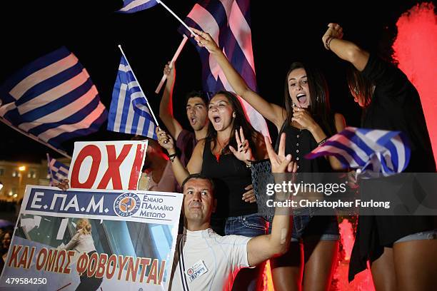 People celebrate in front of the Greek parliament as the people of Greece reject the debt bailout by creditors on July 6, 2015 in Athens, Greece. The...