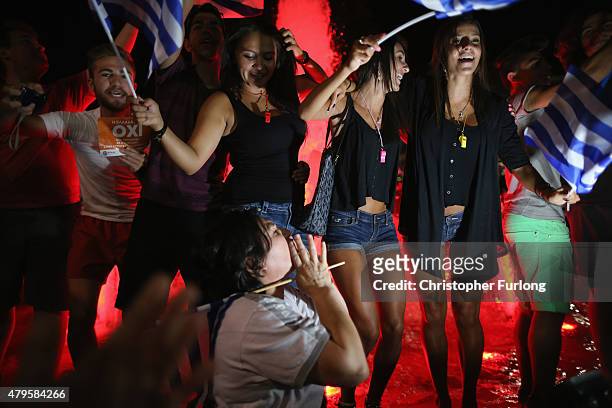 People celebrate in front of the Greek parliament as the people of Greece reject the debt bailout by creditors on July 6, 2015 in Athens, Greece. The...