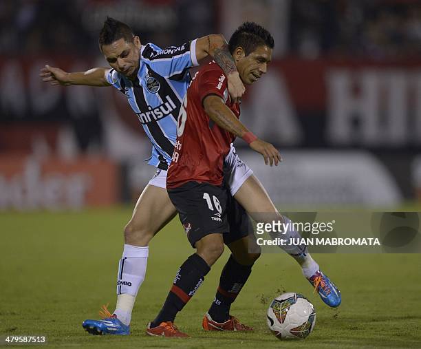 Brazil's Gremio defender Para vies for the ball with Argentina's Newell's Old Boys midfielder Victor Figueroa during their Copa Libertadores 2014...