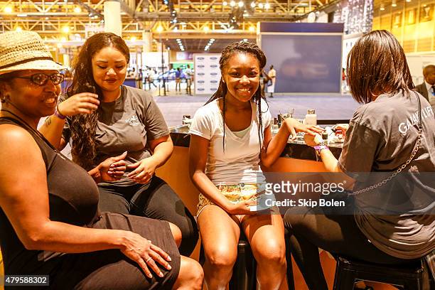 Festivalgoers attend the Samsung Galaxy Experience at ESSENCE Festival on July 5, 2015 in New Orleans, Louisiana.