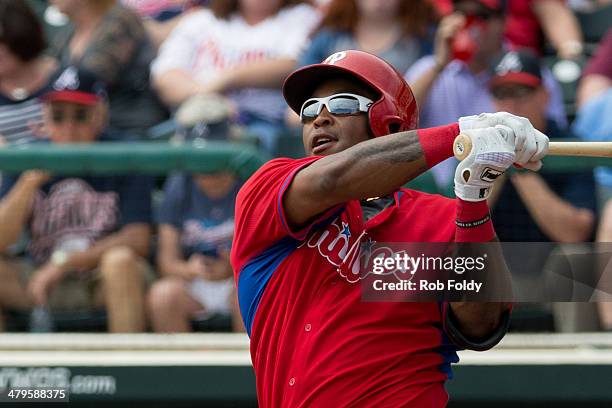 Marlon Byrd of the Philadelphia Phillies follows through with a swing during an at bat during the game against the Atlanta Braves at Champion Stadium...