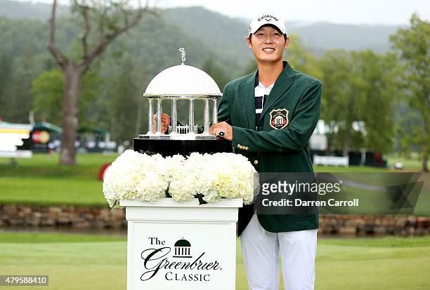 Danny Lee of New Zealand poses with the trophy after winning on the second hole of a sudden death playoff at the Greenbrier Classic held at The Old...