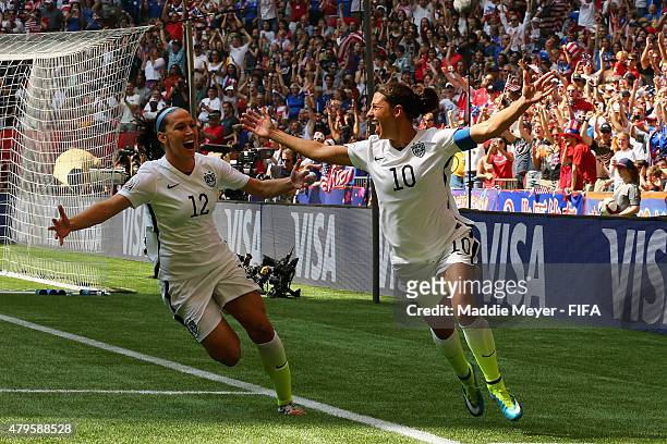 Carli Lloyd of United States of America celebrates with Lauren Holiday after scoring a goal during the FIFA Women's World Cup 2015 final match...