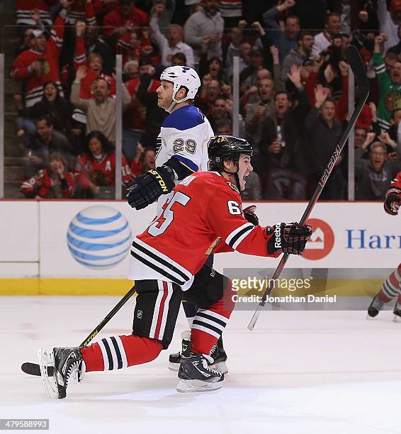 Andrew Shaw of the Chicago Blackhawks celebrates a second period goal as he skates past Steve Ott of the St. Louis Blues at the United Center on...