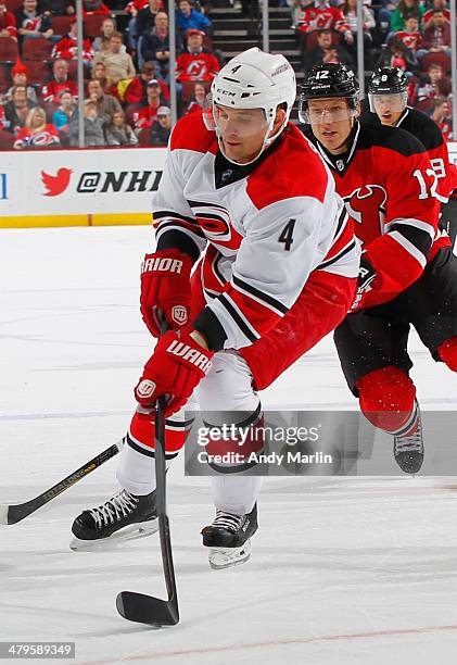 Andrej Sekera of the Carolina Hurricanes plays the puck against the New Jersey Devils during the game at the Prudential Center on March 8, 2014 in...