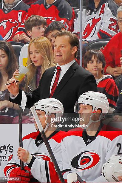 Head coach Kirk Muller of the Carolina Hurricanes gives instructions against the New Jersey Devils during the game at the Prudential Center on March...