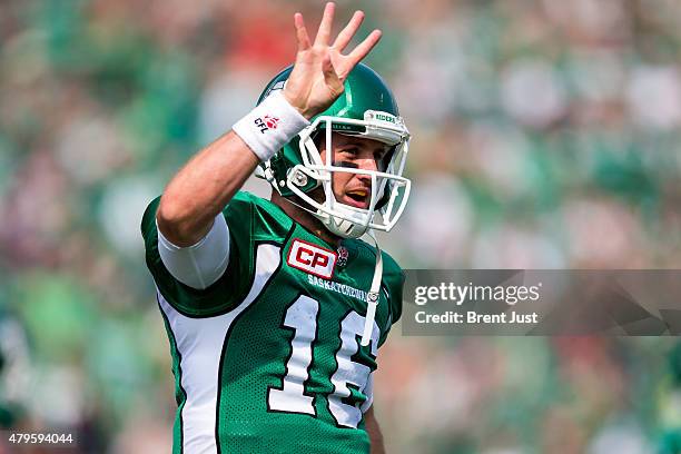 Brett Smith of the Saskatchewan Roughriders flashes four fingers in tribute to injured quarterback Darian Durant after scoring a late touchdown in...