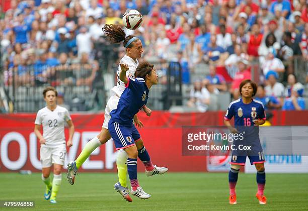 Lauren Holiday of the United States heads the ball against Aya Miyama of Japan in the second half in the FIFA Women's World Cup Canada 2015 Final at...