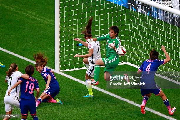 Ayumi Kaihori of Japan lays on the pitch in front of Alex Morgan after Tobin Heath of the United States scores in the second half in the FIFA Women's...