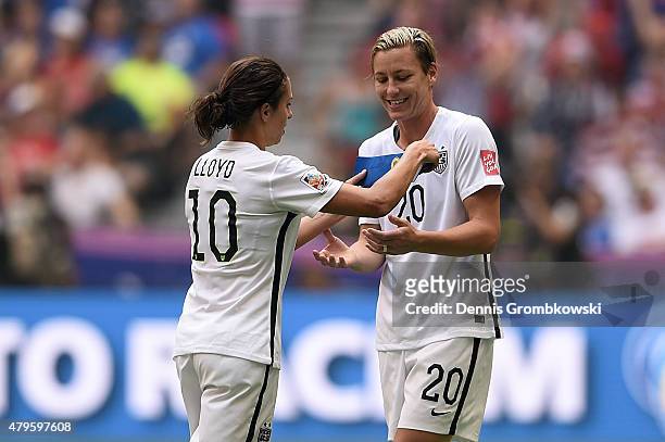 Carli Lloyd gives the captain's armband to teammate Abby Wambach of the United States in the second half against Japan in the FIFA Women's World Cup...