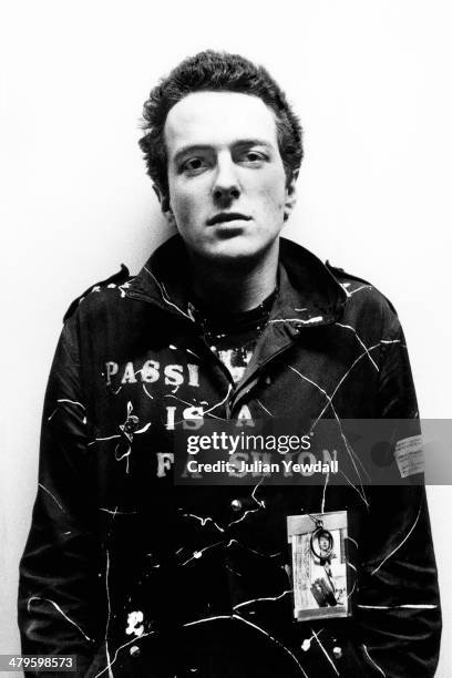 English singer-songwriter Joe Strummer , of punk group The Clash, backstage at a concert at the Royal College of Art , London, 5th November 1976.