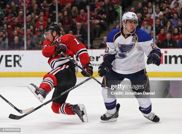 Joanthan Toews of the Chicago Blackhawks falls to the ice after colliding with the stick of Alexander Steen of the St. Louis Blues at the United...