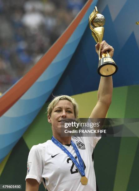 Forward Abby Wambach holds The World Cup as he celebrates the 5-2 victory in the final football match between USA and Japan during their 2015 FIFA...