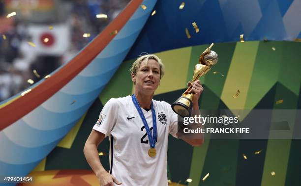 Forward Abby Wambach holds The World Cup as he celebrates the 5-2 victory in the final football match between USA and Japan during their 2015 FIFA...