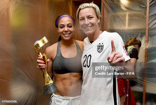 Sydney Leroux of USA and Abby Wambach of USA pose with the trophy in the locker room after winning the FIFA Women's World Cup 2015 Final between USA...